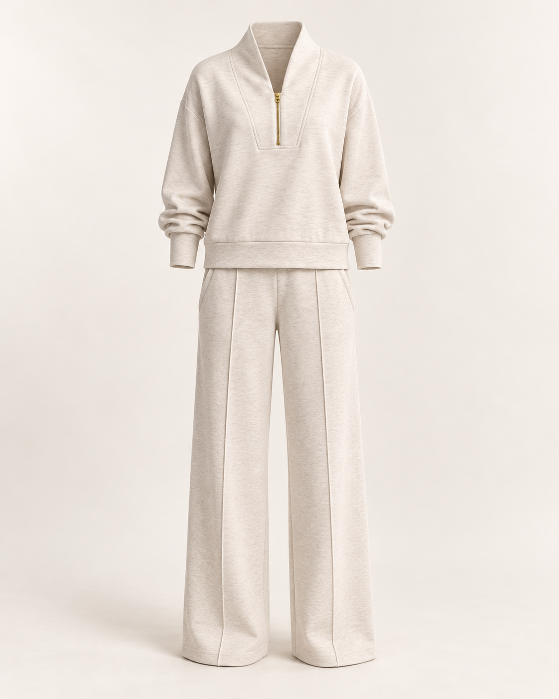 Apricot Quarter-Zip Travel Set with a stand collar, gold zipper and wide-leg pintuck pants on an ivory background